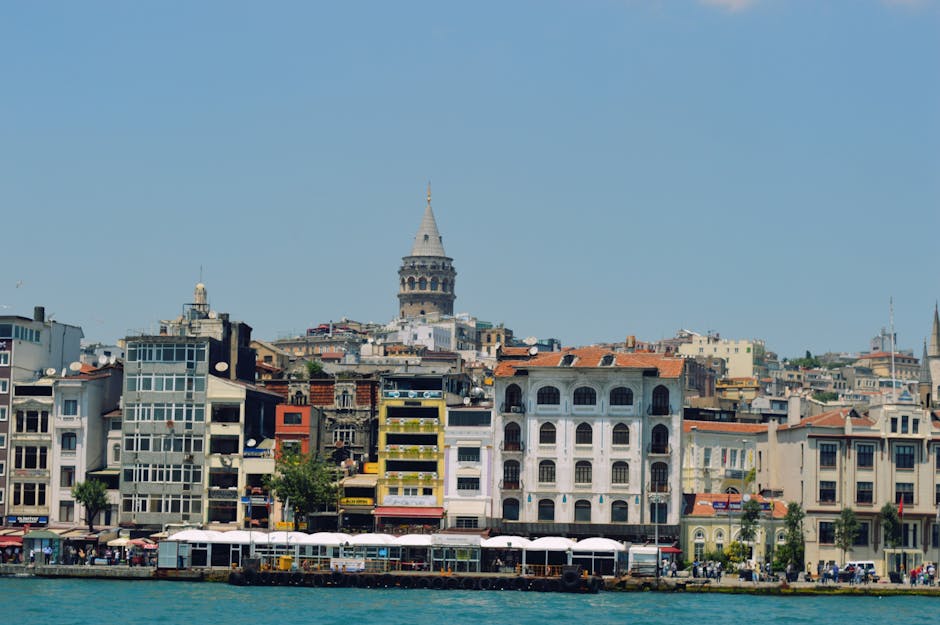 A vibrant view of the Galata Tower and Istanbul skyline under a clear blue sky during summer.
