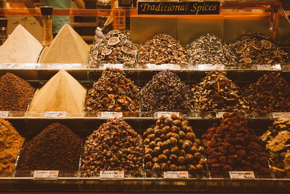 Colorful assortment of traditional spices on display in a vibrant market setting.