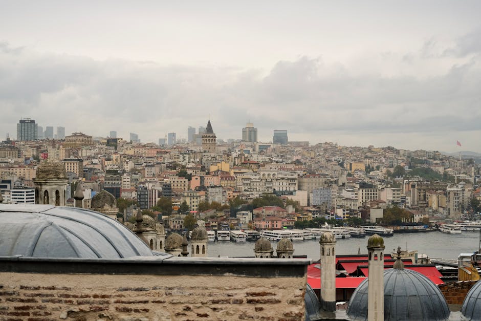 Skyline view of Istanbul featuring the iconic Galata Tower, historic architecture, and Bosphorus.