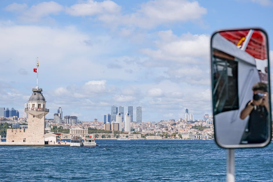 Capture of Maiden's Tower and modern Istanbul skyline from a boat on the Bosphorus.